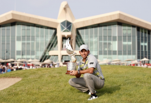 Pablo Larrazabal of Spain holds his trophy after winning..
